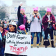 Angela Peoples holding sign (Kevin Banatte)